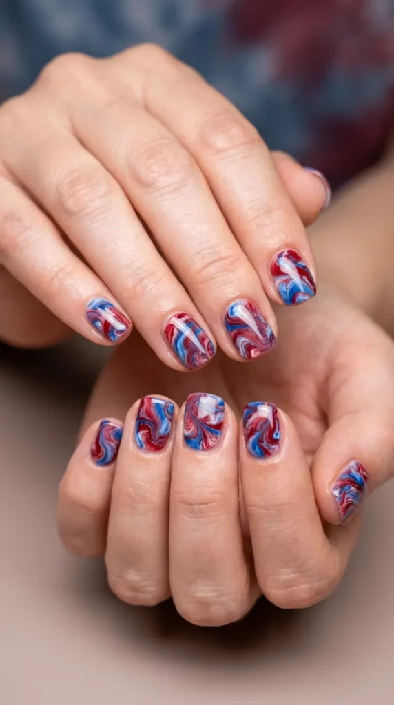 Blue and red marble swirl nail design