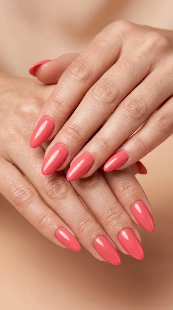 Coral pink almond nails with glossy shine