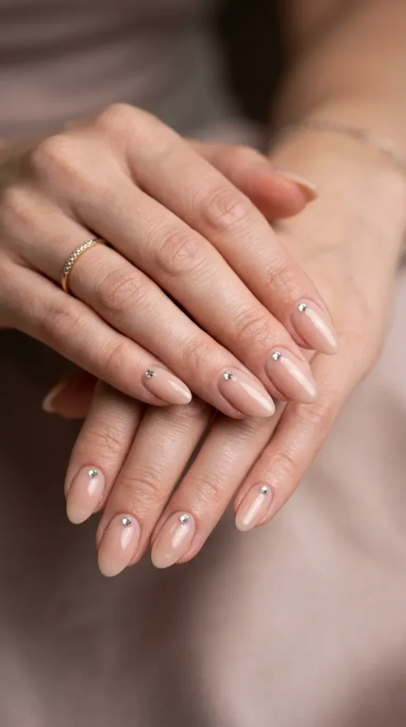 Nude nails with single rhinestone accent per finger