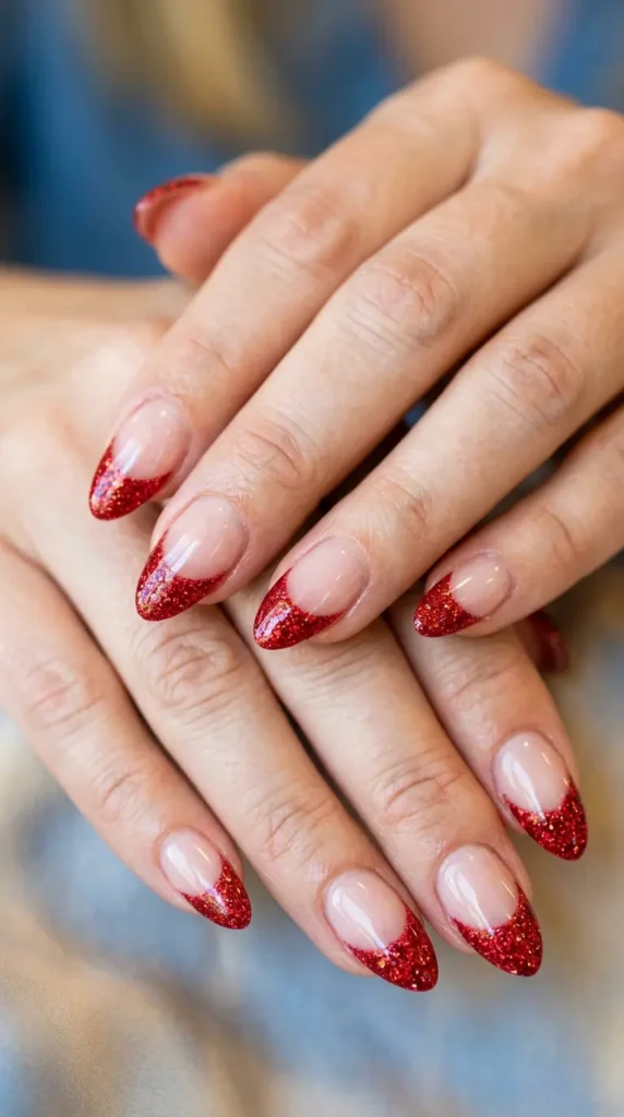 red glitter tips on almond-shaped nails