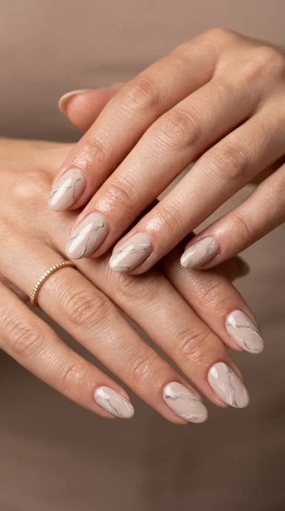 Soft beige nails with subtle marble effect