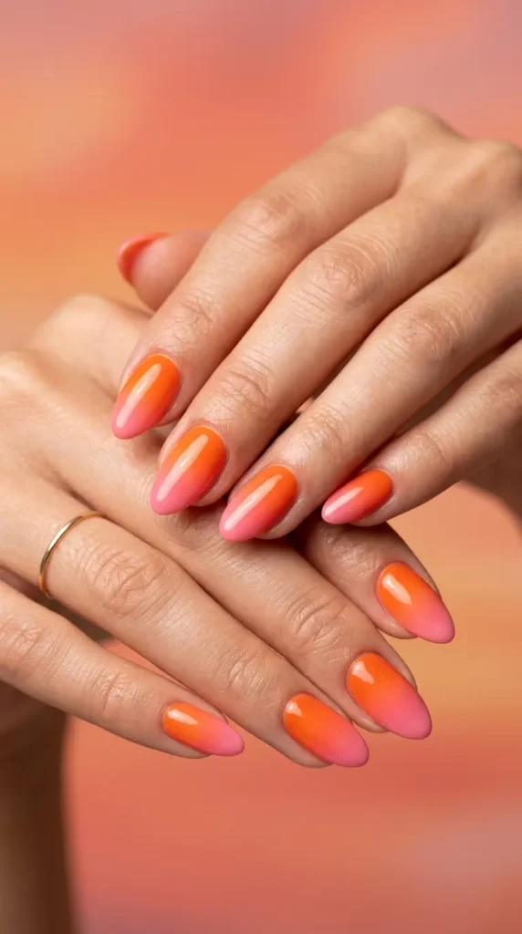 Tropical sunset ombré nails (orange to pink gradient)
