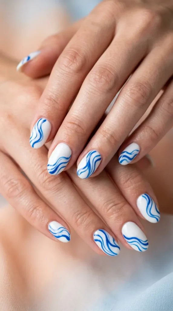 White nails with abstract blue wave lines