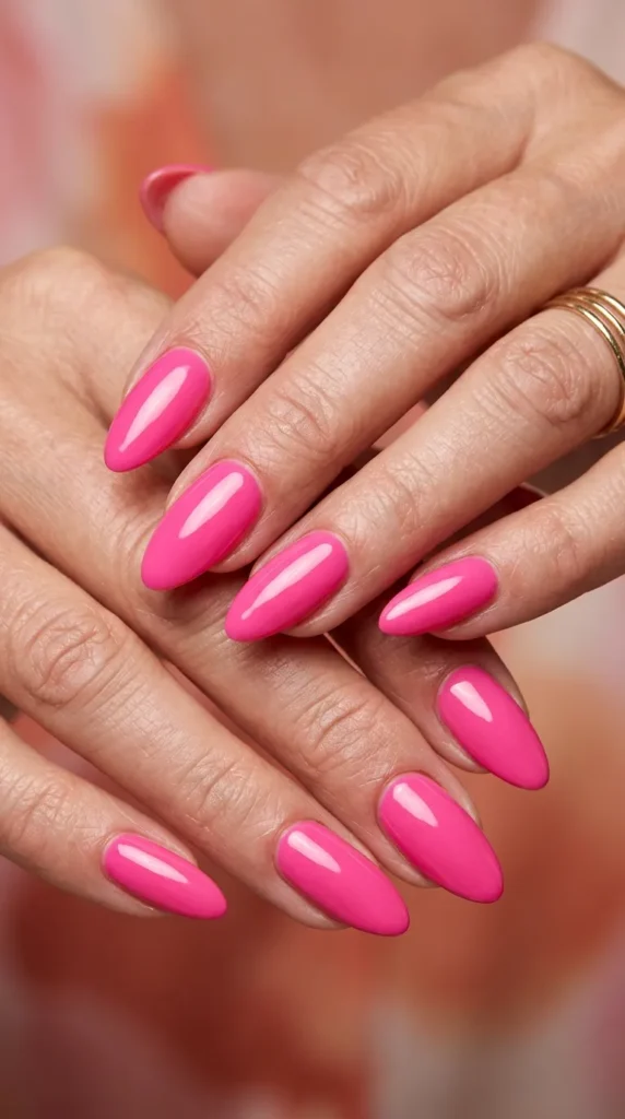 Hot pink almond nails with glossy top coat