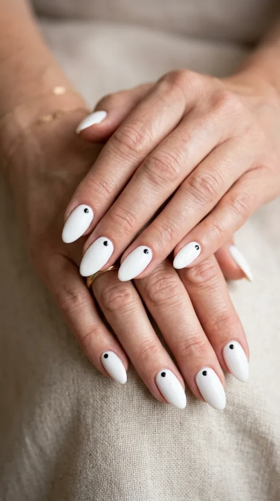Minimalist white almond nails with tiny dots