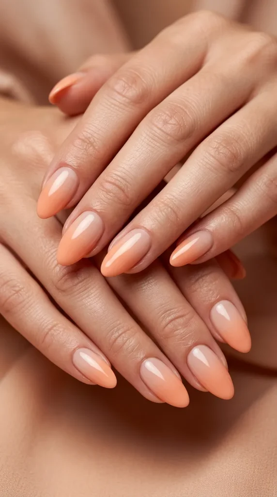 Peach to nude glossy ombre manicure