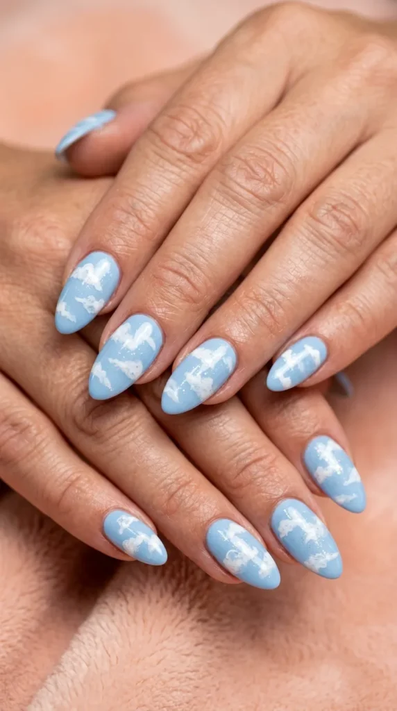 Sky blue almond nails with white cloud art