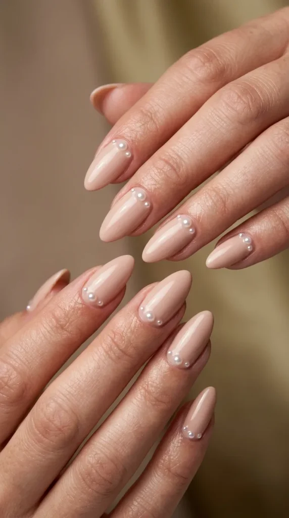 Soft nude almond nails with pearl accents