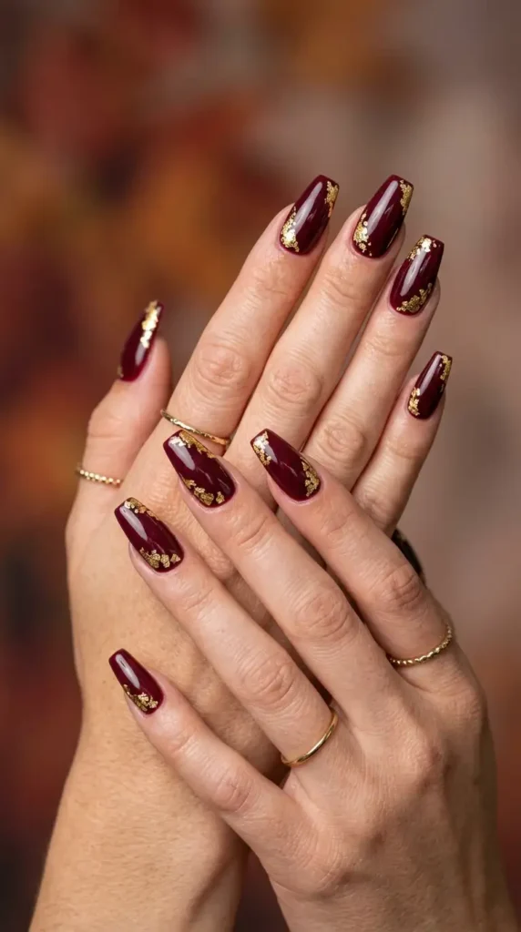 Burgundy Nails with Gold Leaf Accents