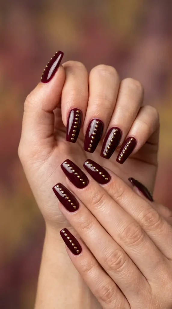 Burgundy Nails with Tiny Gold Studs