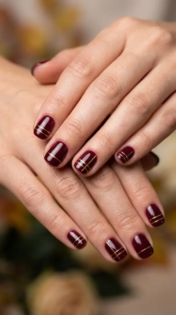 Rich Burgundy Nails with Fine Gold Lines
