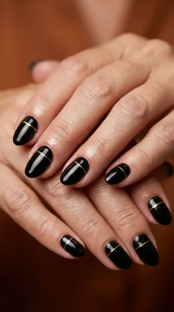 Black Oval Nails with Minimal Gold Lines
