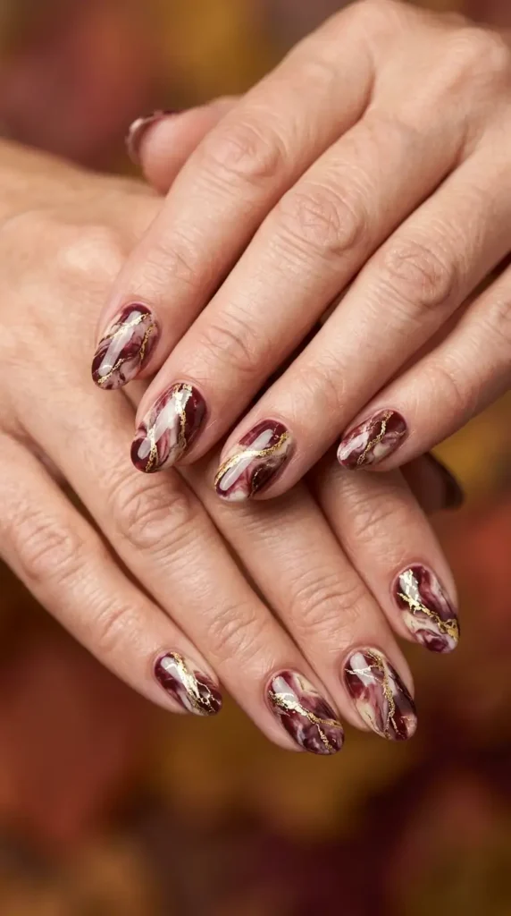Burgundy and Gold Foil Marble Oval Nails